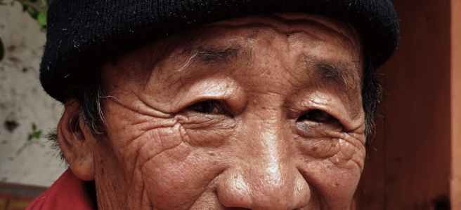 smiling man wearing red scarf and black beanie